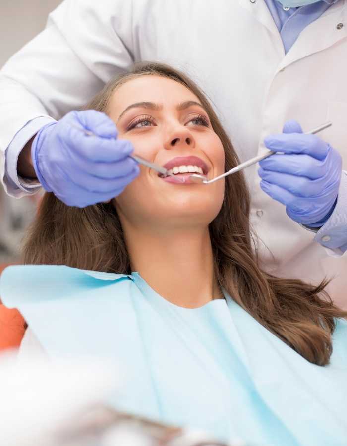 Dental services - dentist implanting an dental implant